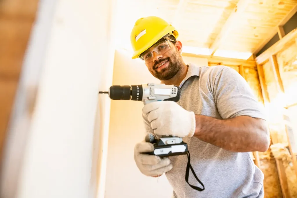 Retrato de um instalador satisfeito com a reforma usando drywall. Foto: Reprodução / Canva Pro.