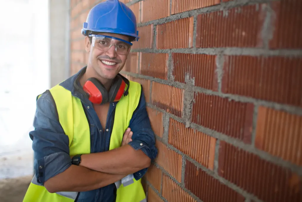 Trabalhador feliz ao ver sua construção tendo excelente andamento. Foto: Reprodução / Canva Pro.